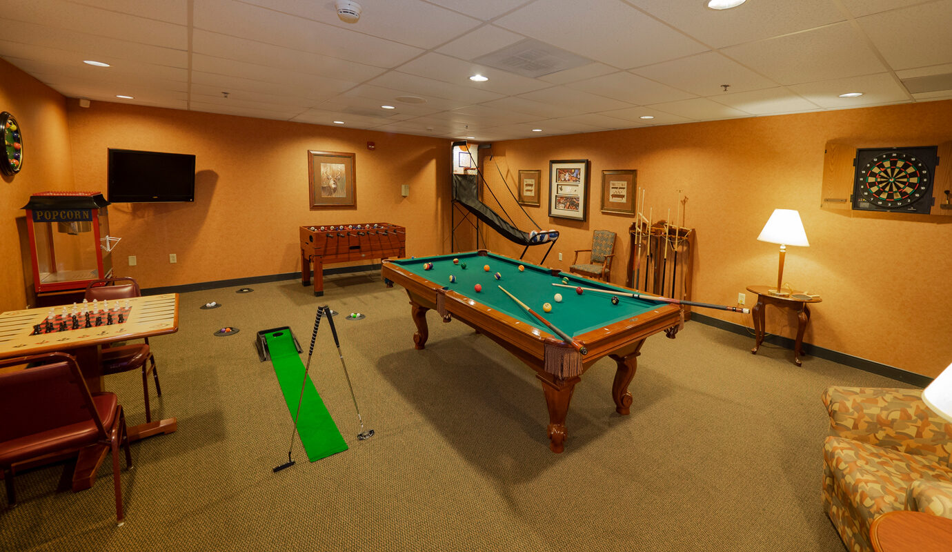 Game room with pool table, chess, darts, and putting station