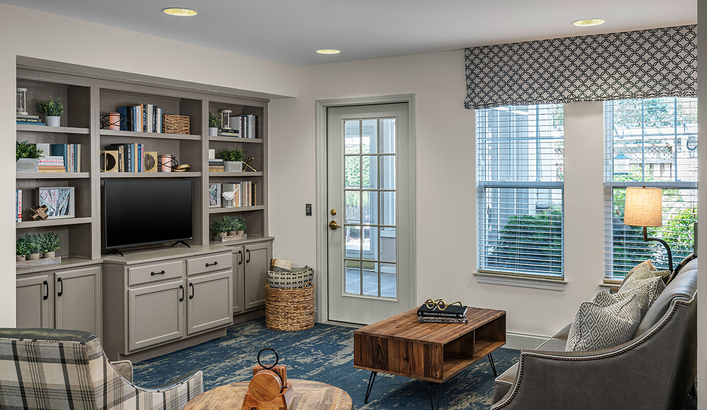 Common area with seating and TV on bookshelves