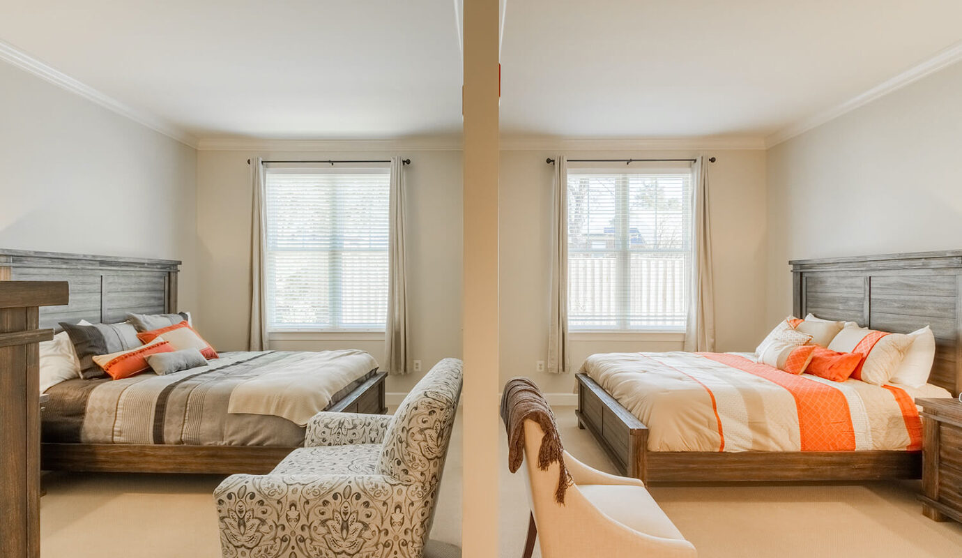 Two queen size beds separated by a wall