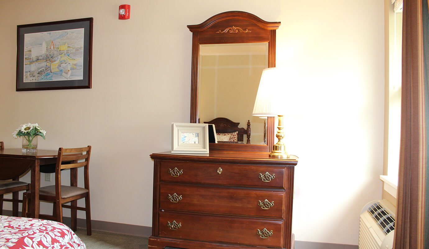 Dresser with mirror next to small dining table