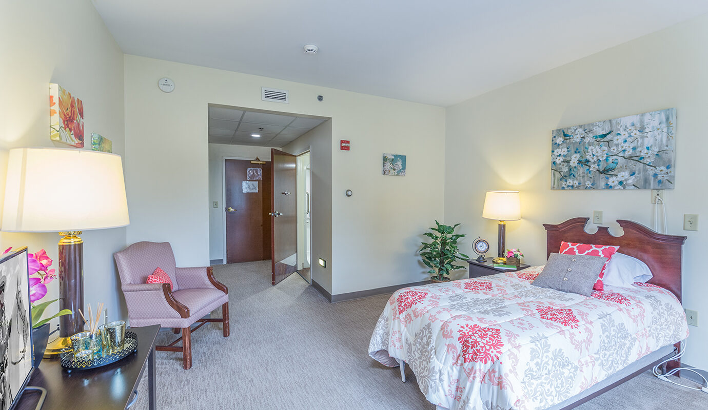 Bedroom with bed, side table, and chair