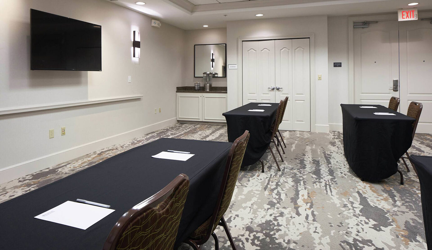 Meeting space with tables and TV