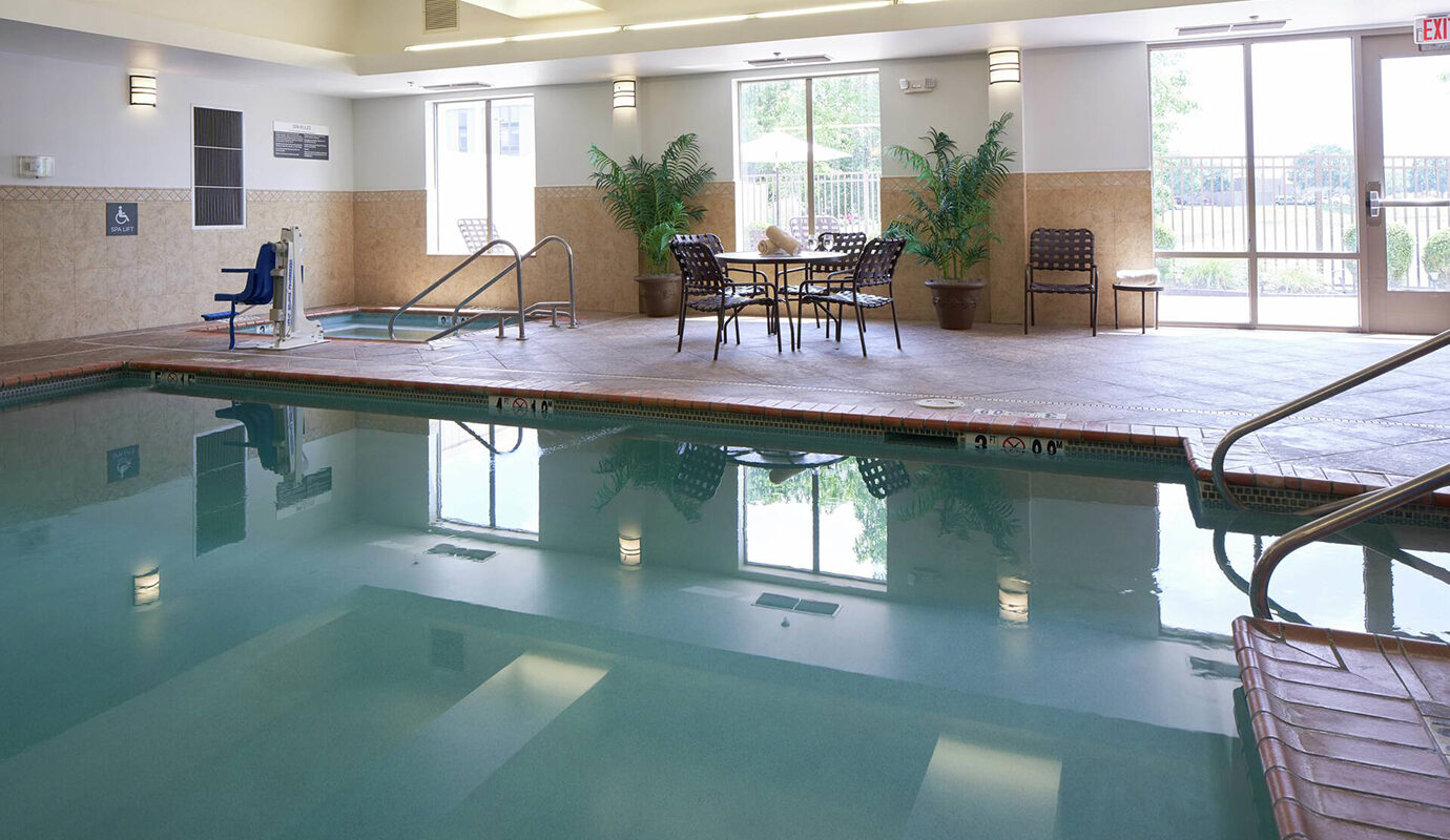 Pool and hot tub with seating area