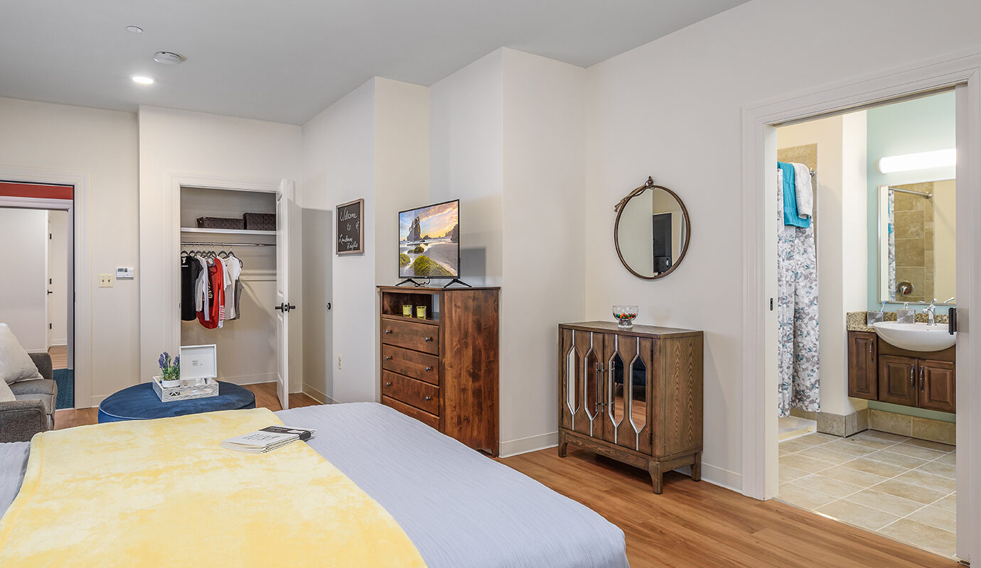 Decorated bedroom with view of bathroom from bed
