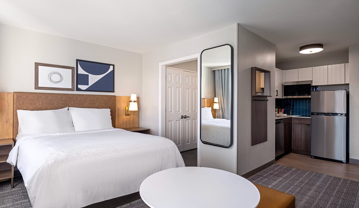 Guest room with queen size bed and kitchenette