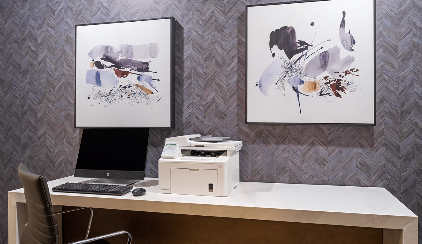 Work space with desktop computer, desk, and printer
