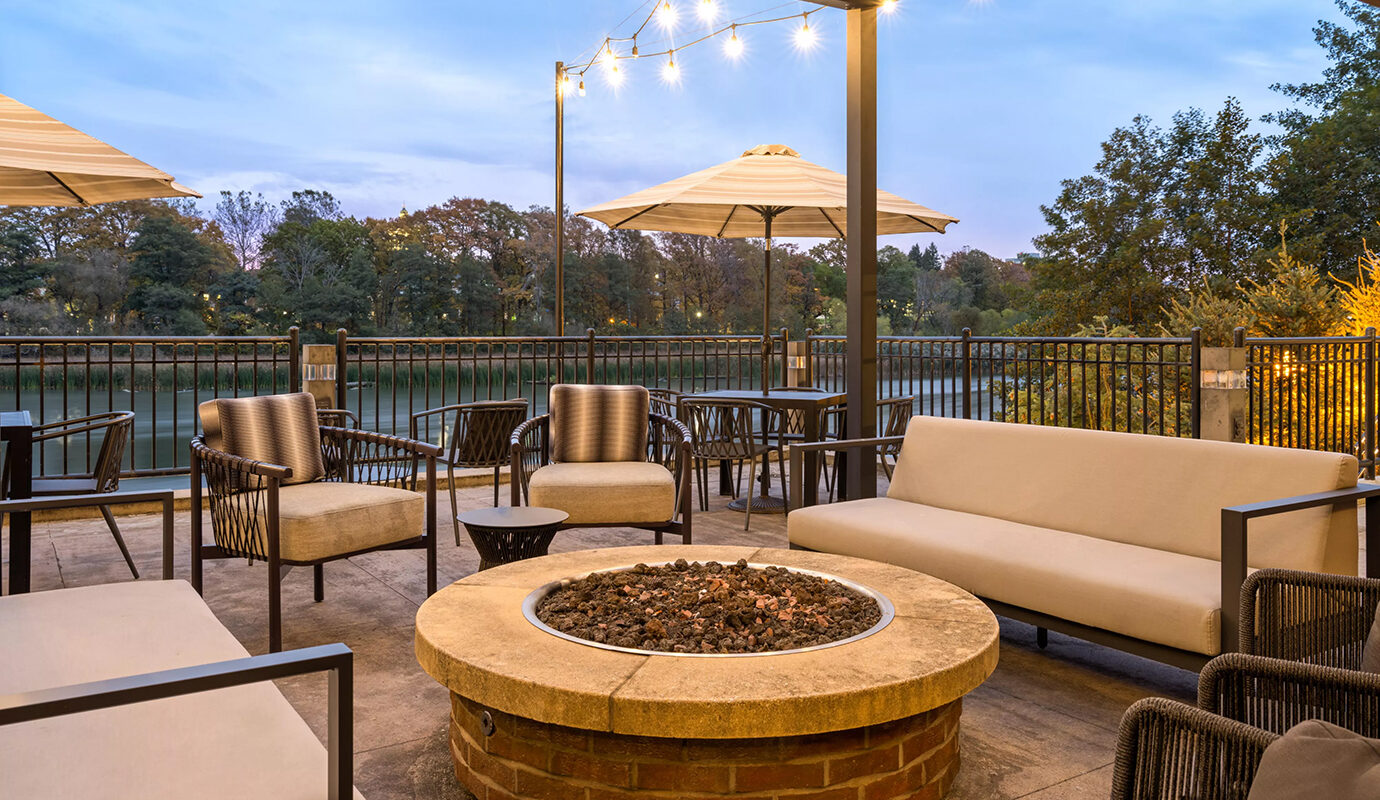 Outdoor fireplace on patio with waterfront view