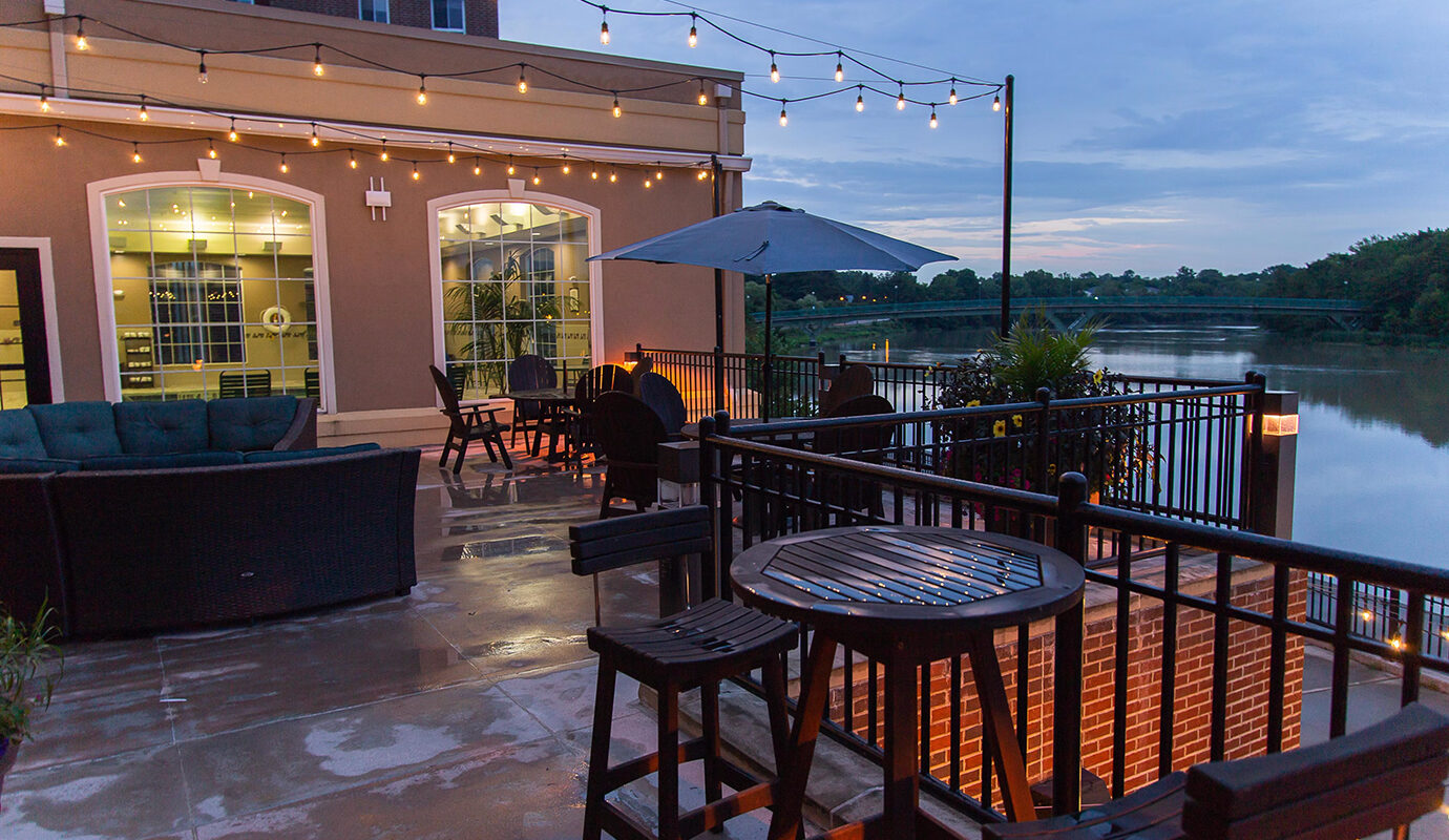 Outdoor waterfront second-floor patio with seating areas