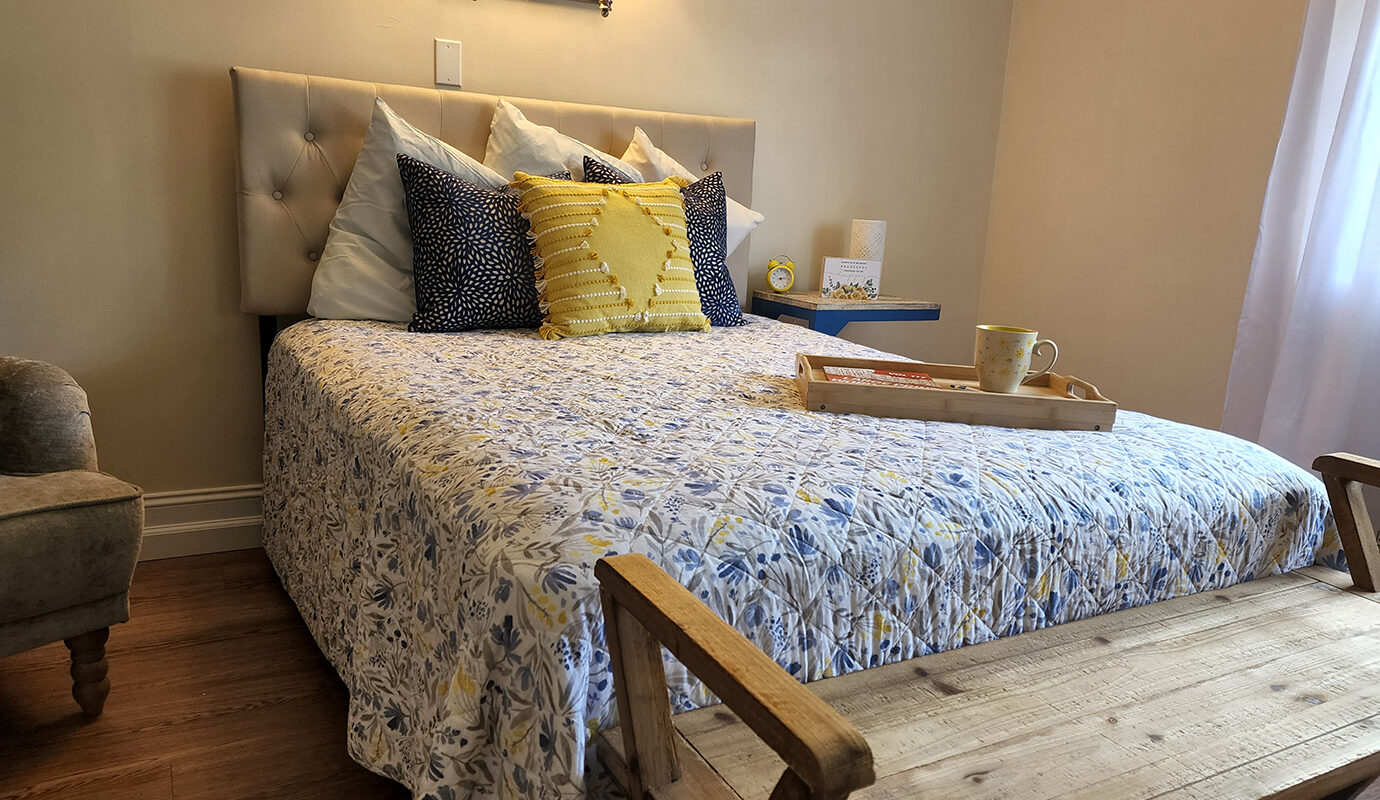 Cute bedroom with bed, bench and side table
